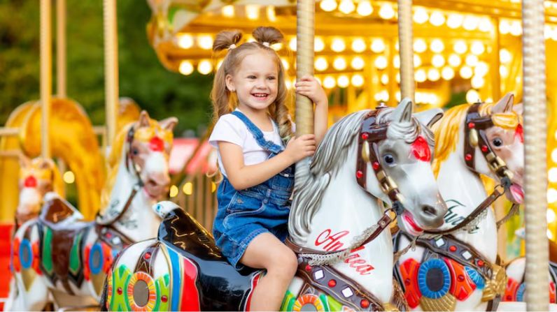 Children enjoying hired amusement rides at an event in London